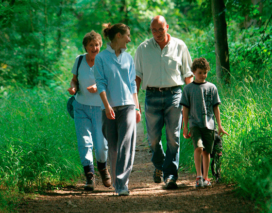 Family strolling through one of our woodland trails at Bolton Abbey
