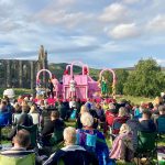 Outdoor theatre at Bolton Abbey on a sunny summer's evening near the priory ruins