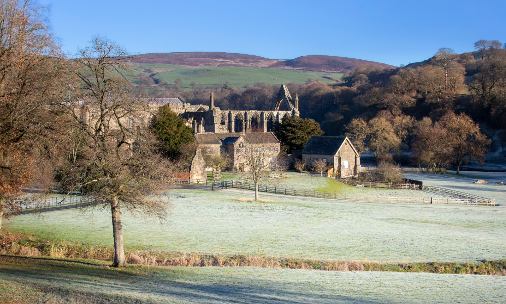 View of Bolton Abbey Priory with frosted fields in the foreground.